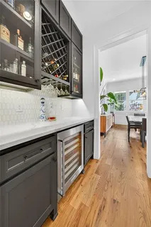 a view of a kitchen area with furniture and wooden floor