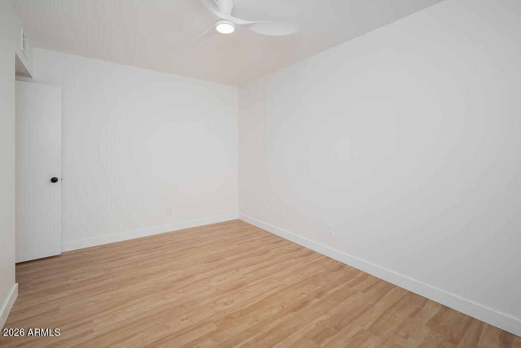 720 South Dobson Road, Unit 85 Mesa, AZ 85202 - Photo 13 of 25 a view of an empty room with wooden floor