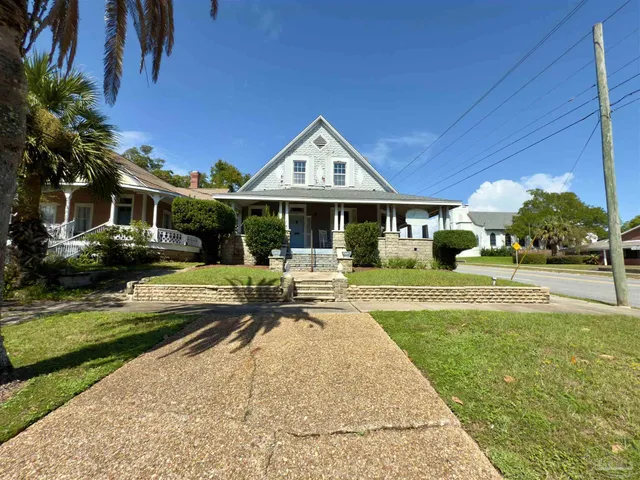 a front view of a house with a yard table and chairs