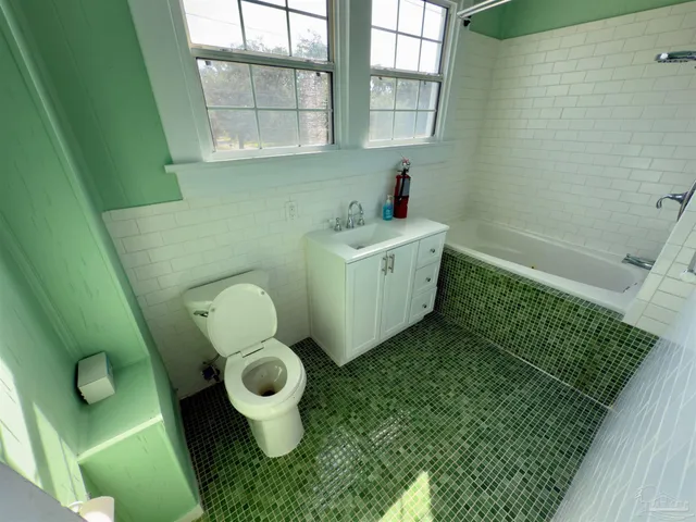 a walk in closet with a hardwood floor