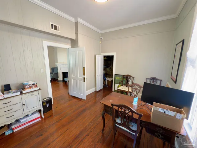 a workspace with wooden floor and a window