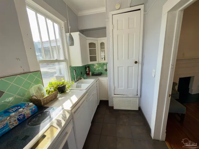 a view of a hallway with windows and plants