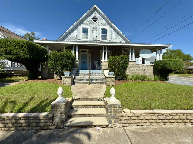 a front view of a house with a yard garden