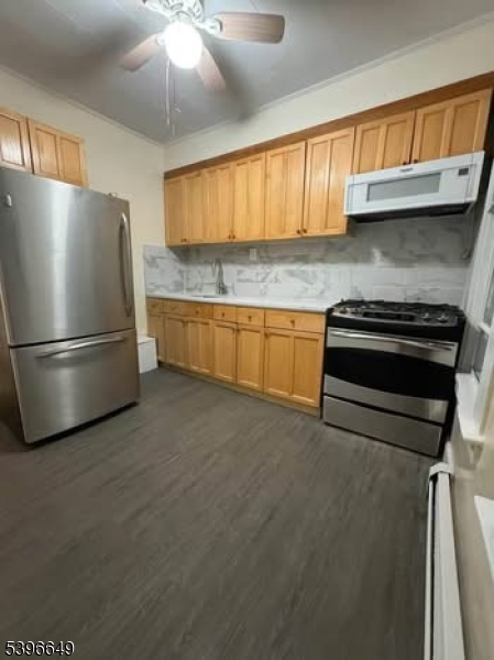 a kitchen with granite countertop stainless steel appliances and wooden cabinets