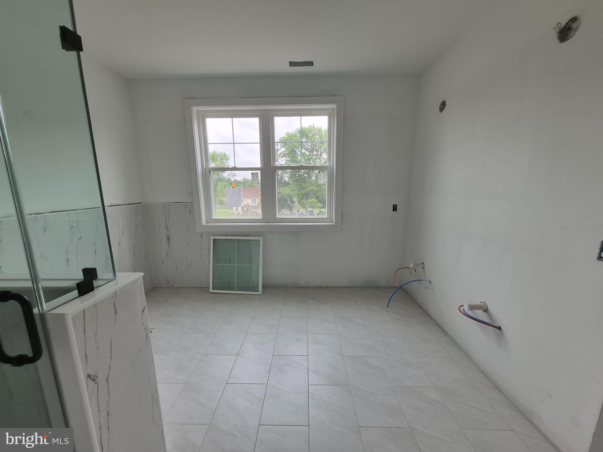 324 Bishop Hollow Road Newtown Square, PA 19073 - Photo 16 of 37 a view of an empty room with a window