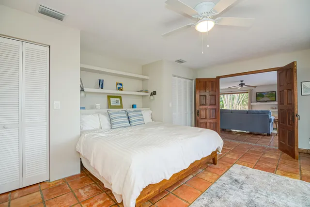a bathroom with a granite countertop sink a mirror a toilet and a bathtub