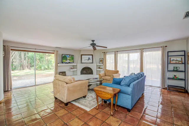 a living room with fireplace furniture and a window