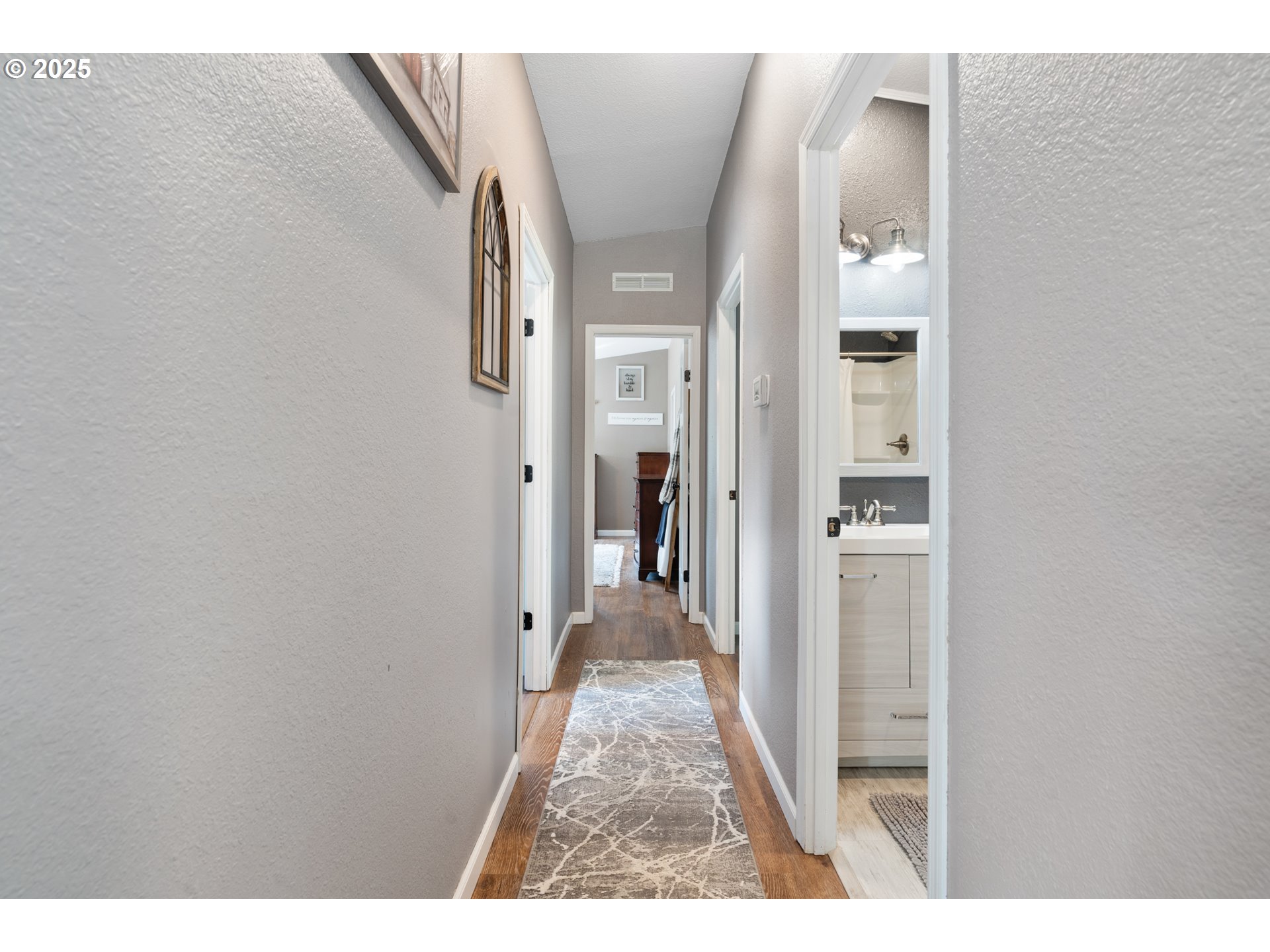 30402 Townsend Road Lebanon, OR 97355 - Photo 11 of 46 a view of a hallway with wooden floor and a bathroom