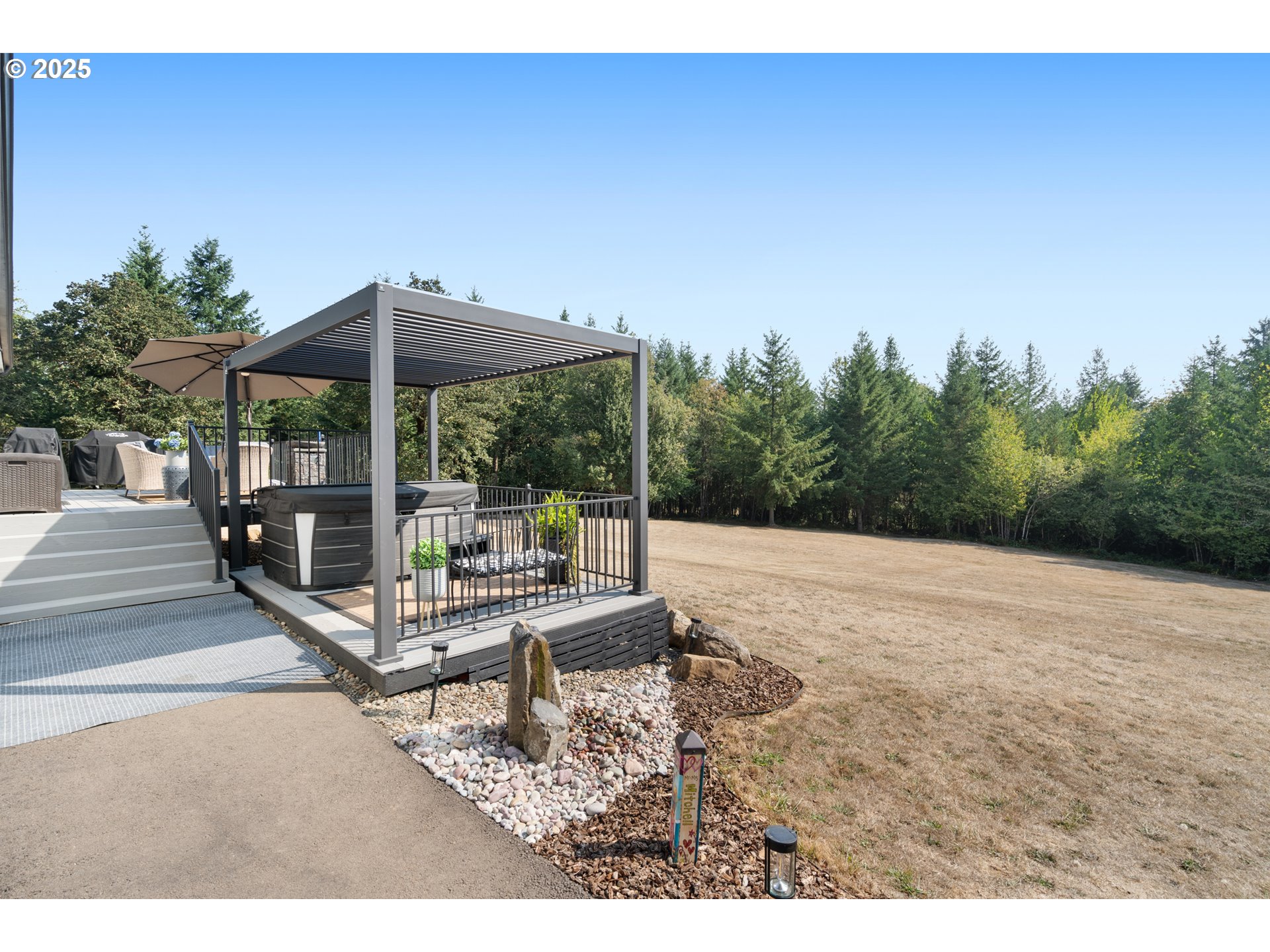 30402 Townsend Road Lebanon, OR 97355 - Photo 26 of 46 a view of a patio with a table and chairs under an umbrella