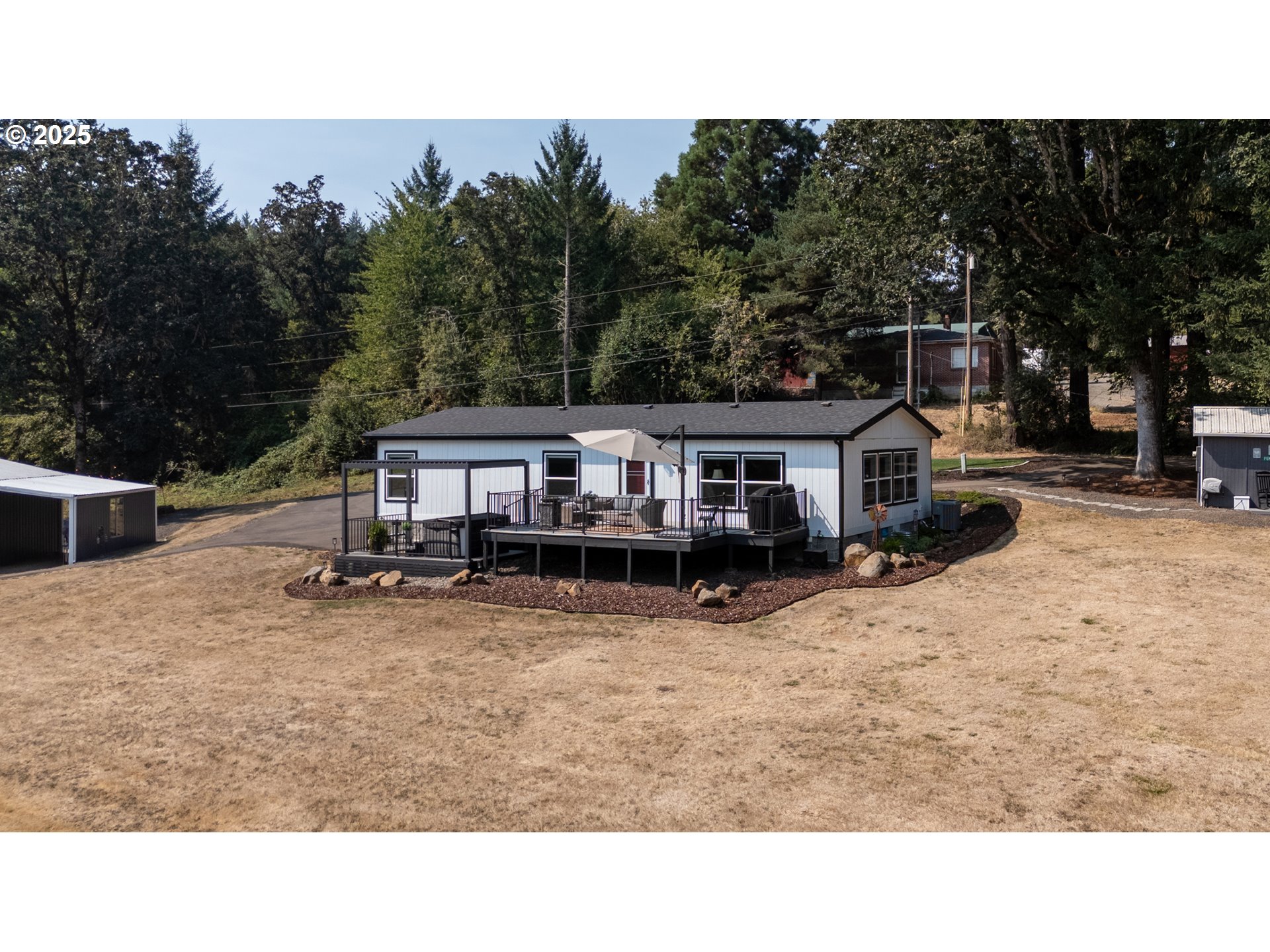 30402 Townsend Road Lebanon, OR 97355 - Photo 3 of 46 a balcony with furniture and a park