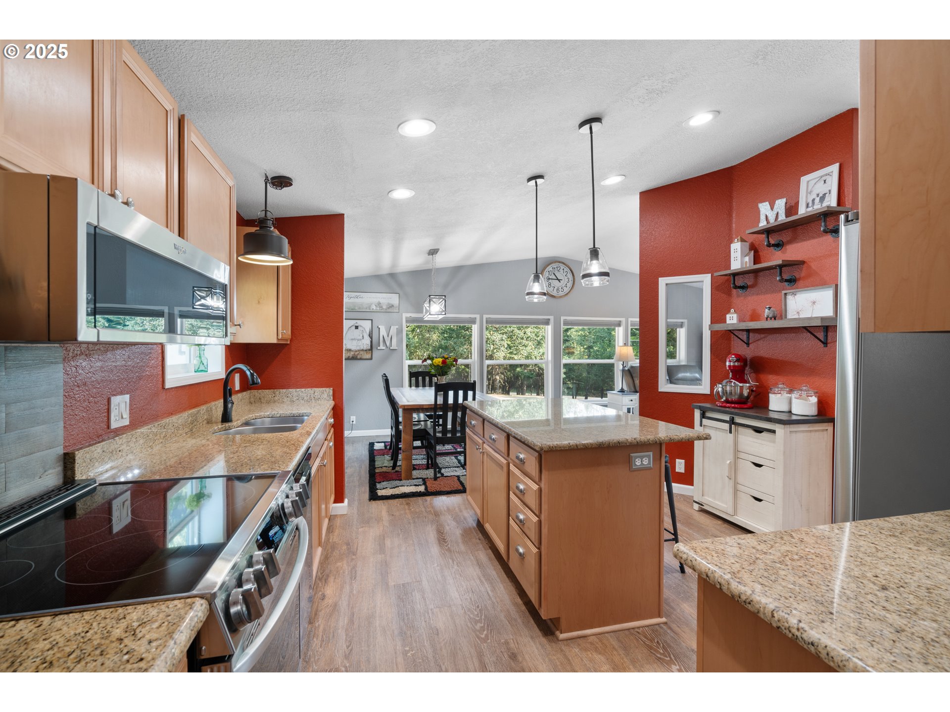 30402 Townsend Road Lebanon, OR 97355 - Photo 8 of 46 a kitchen with stainless steel appliances kitchen island granite countertop a stove a refrigerator a sink and wooden cabinets