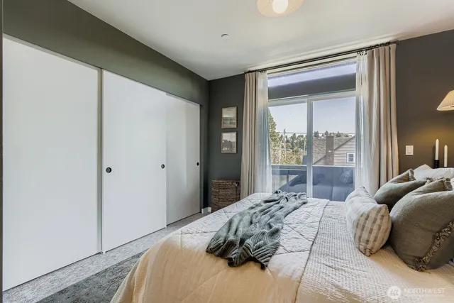 a bedroom with a large bed and a large window