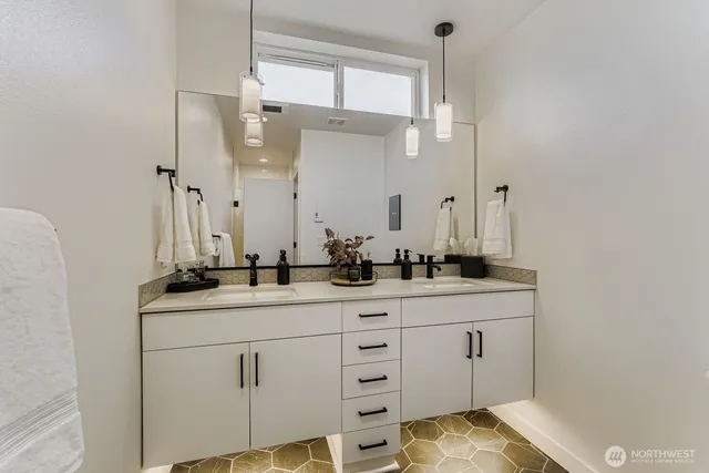 a bathroom with a granite countertop sink and a mirror