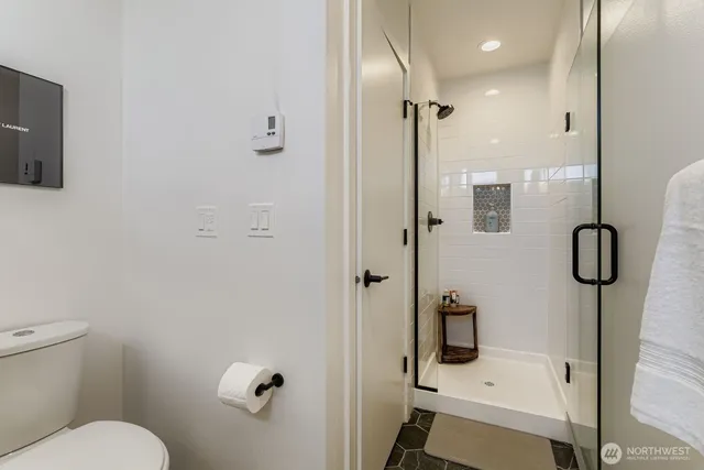 a bathroom with a shower toilet and sink