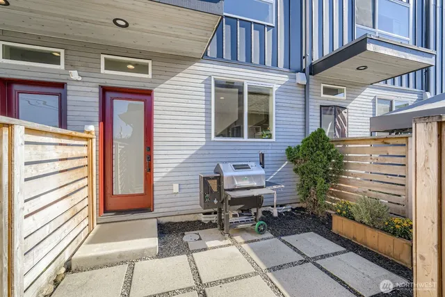 a view of a patio with a table and chairs and potted plants