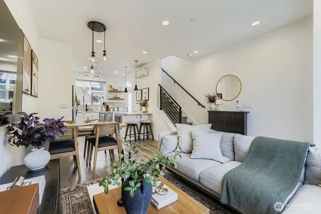 a living room with furniture and a chandelier