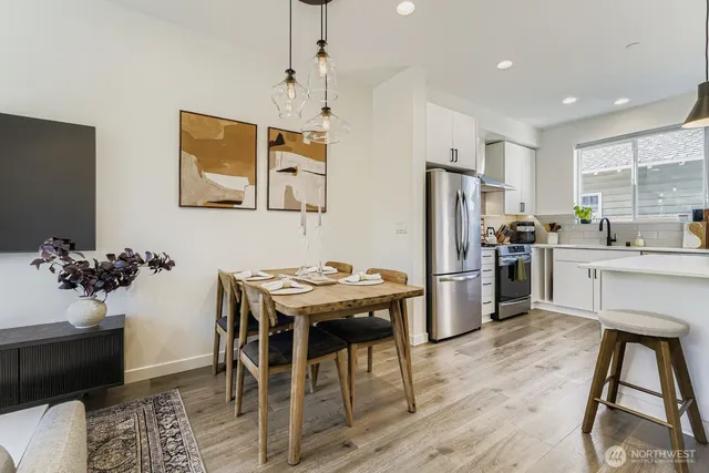 a kitchen with stainless steel appliances kitchen island a refrigerator and a stove