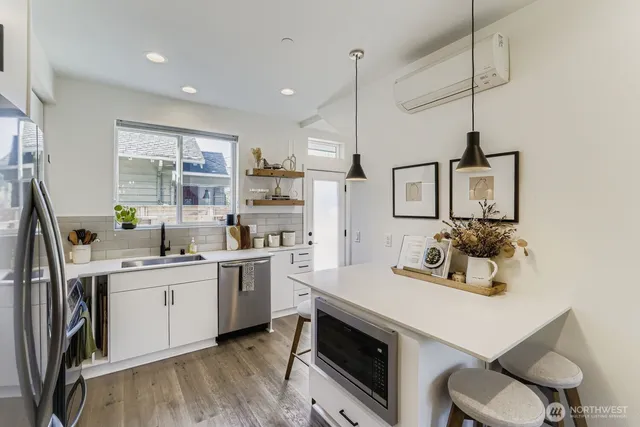 a kitchen with a sink dishwasher a stove and a refrigerator with wooden floor