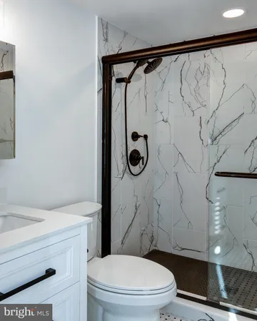 a bathroom with a toilet and a shower