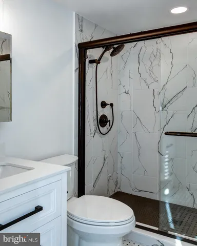 a bathroom with a toilet and a shower