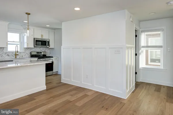 a kitchen with a refrigerator and a stove top oven