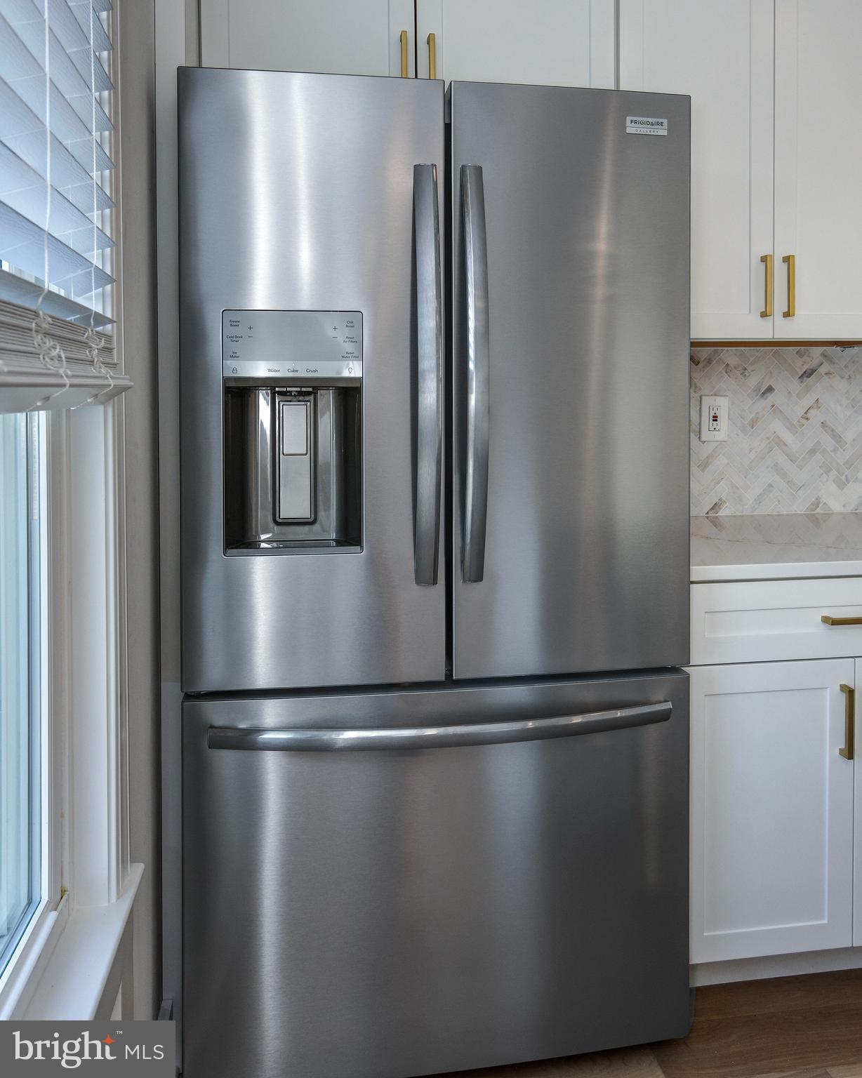 13 Wilkins Avenue Haddonfield, NJ 08033 - Photo 8 of 20 a close view of a refrigerator in kitchen and stainless steel appliances wooden cabinet