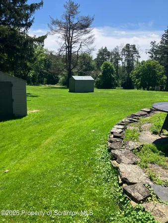a view of a garden with a building in the background