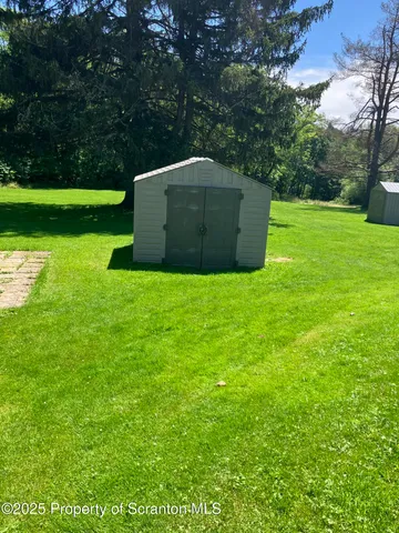 a view of a field of grass and trees