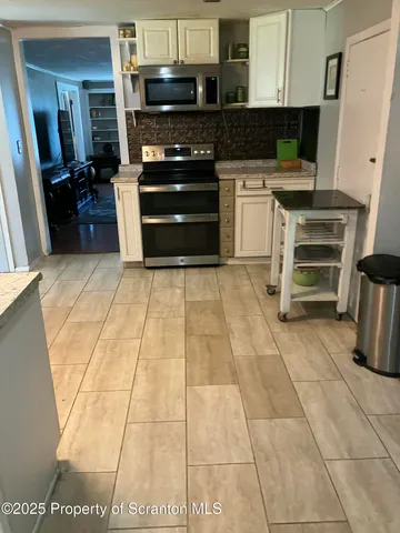 a kitchen with granite countertop a stove and a refrigerator