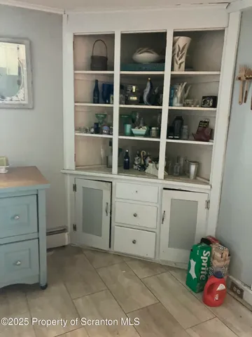 a room with a window and cabinet