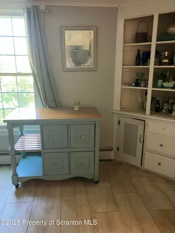 a room with a white wooden closet with wooden floor