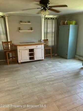 a living room with furniture window and wooden floor