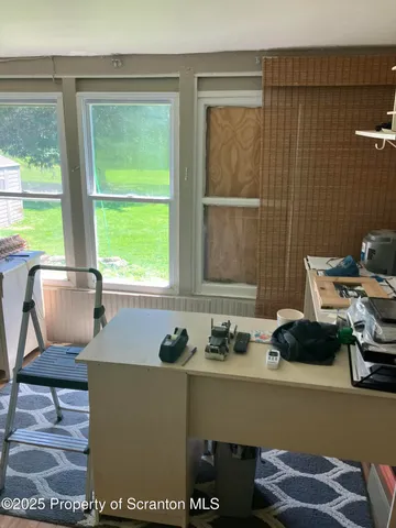 a view of a refrigerator in kitchen and utility room
