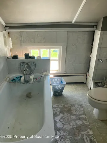 a bedroom with a bed and a television