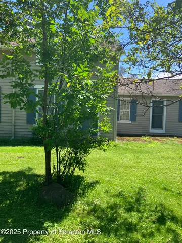 a view of a house with a backyard