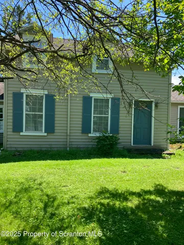 a house that has a big yard with large trees