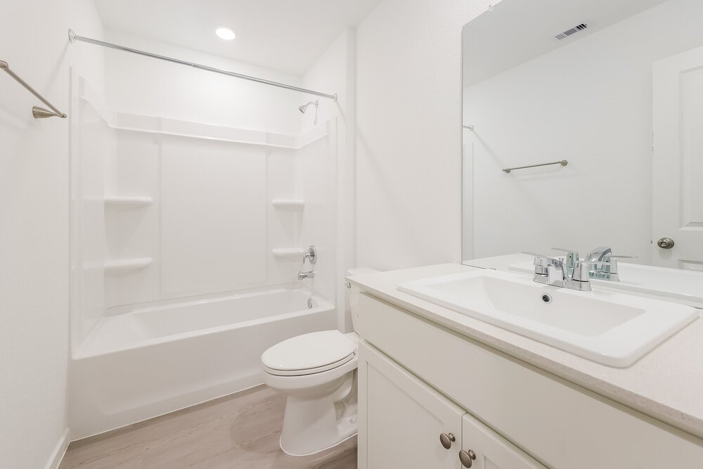 1527 Sunset Ridge Drive Conroe, TX 77306 - Photo 15 of 16 a bathroom with a sink a toilet and a bathtub