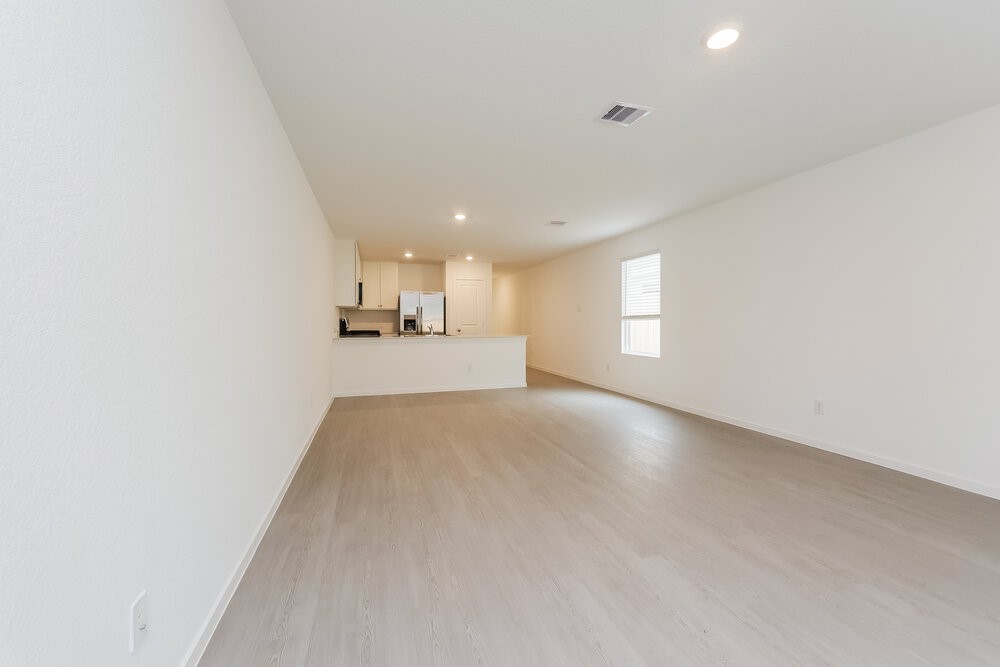 1527 Sunset Ridge Drive Conroe, TX 77306 - Photo 3 of 16 a view of empty room with wooden floor and window