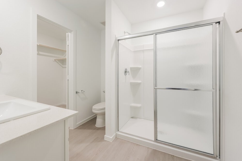 1527 Sunset Ridge Drive Conroe, TX 77306 - Photo 10 of 16 a bathroom with a glass shower door