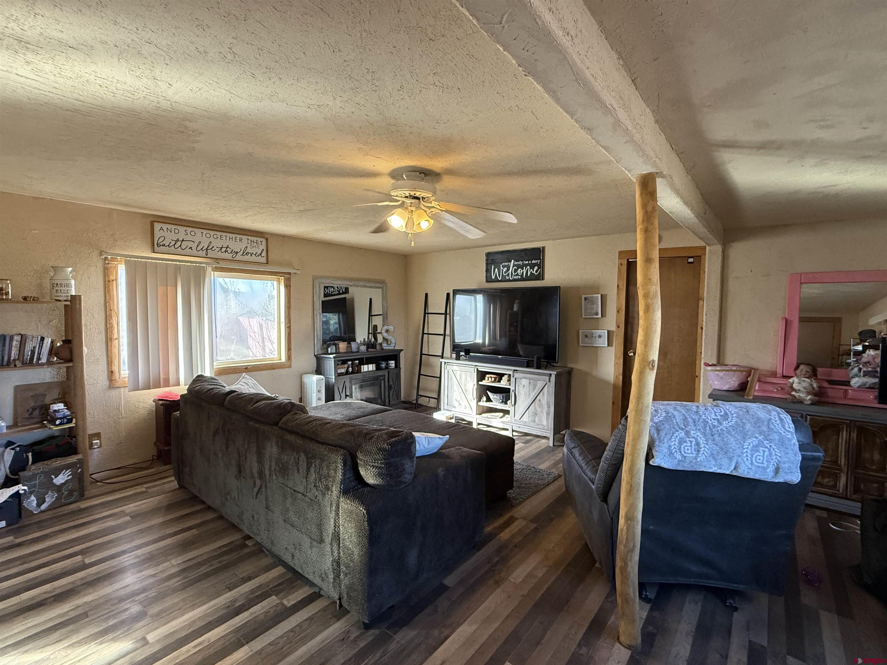 35575 Rd H.5 Mancos, CO 81328 - Photo 4 of 12 a living room with furniture a flat screen tv and kitchen view