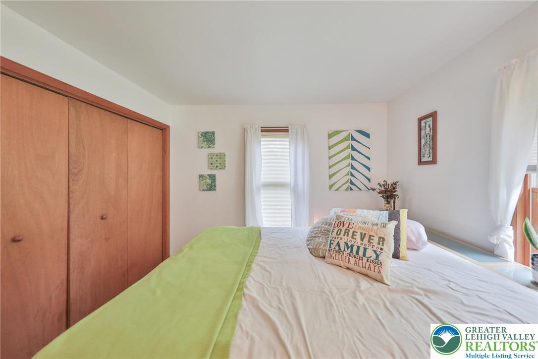 4608 Pine Ridge Drive West Bushkill, PA 18324 - Photo 37 of 62 Natural light filters into this serene bedroom, offering a peaceful retreat.