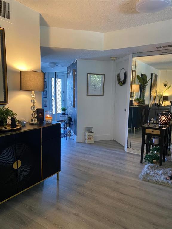 9091 Lime Bay Boulevard, Unit 304 Tamarac, FL 33321 - Photo 11 of 25 a living room with furniture and wooden floor