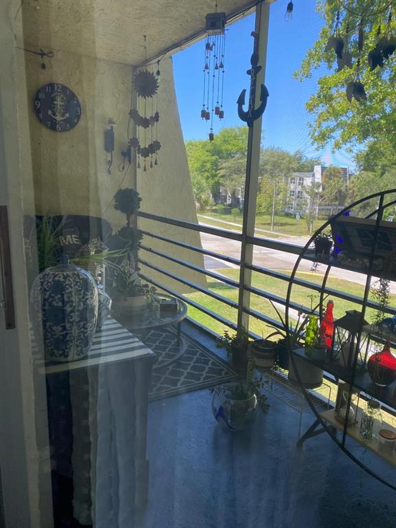 9091 Lime Bay Boulevard, Unit 304 Tamarac, FL 33321 - Photo 19 of 25 a room with lots of potted plants