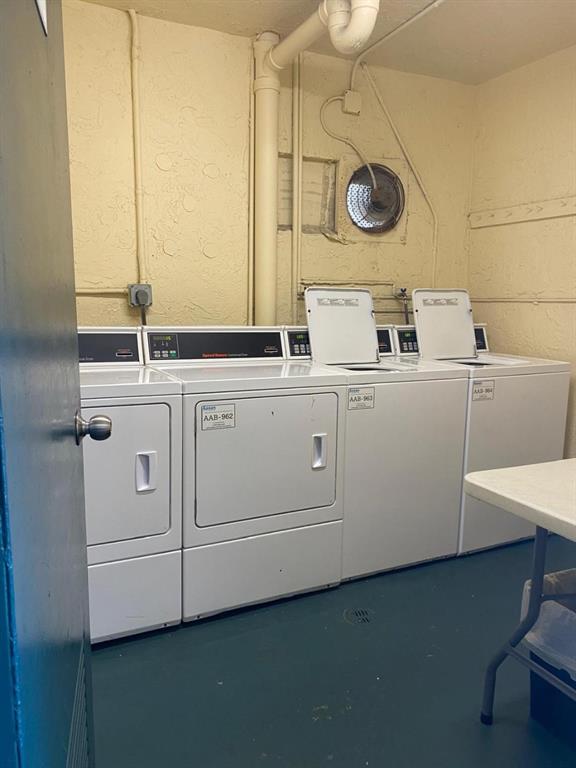 9091 Lime Bay Boulevard, Unit 304 Tamarac, FL 33321 - Photo 20 of 25 a utility room with dryer and washer