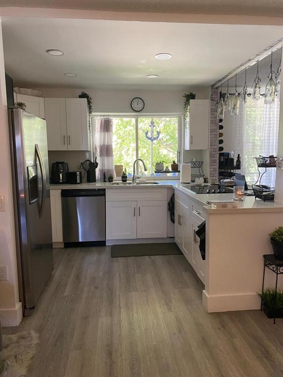 9091 Lime Bay Boulevard, Unit 304 Tamarac, FL 33321 - Photo 7 of 25 a kitchen with stainless steel appliances granite countertop a stove a sink and a refrigerator
