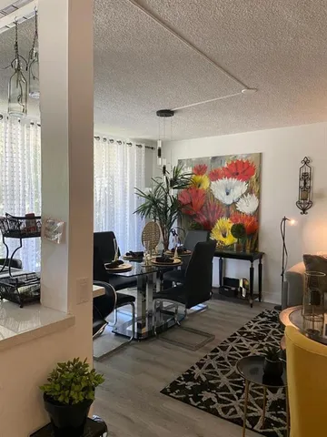 a living room with furniture a piano and a flat screen tv
