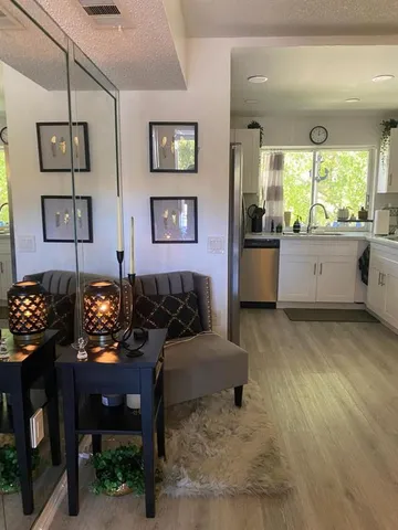 a living room with furniture and paintings on the wall