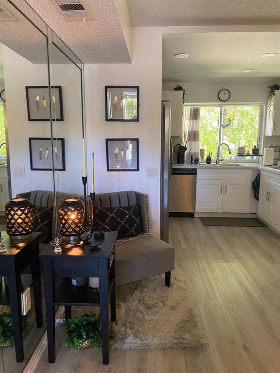 9091 Lime Bay Boulevard, Unit 304 Tamarac, FL 33321 - Photo 9 of 25 a living room with furniture and paintings on the wall