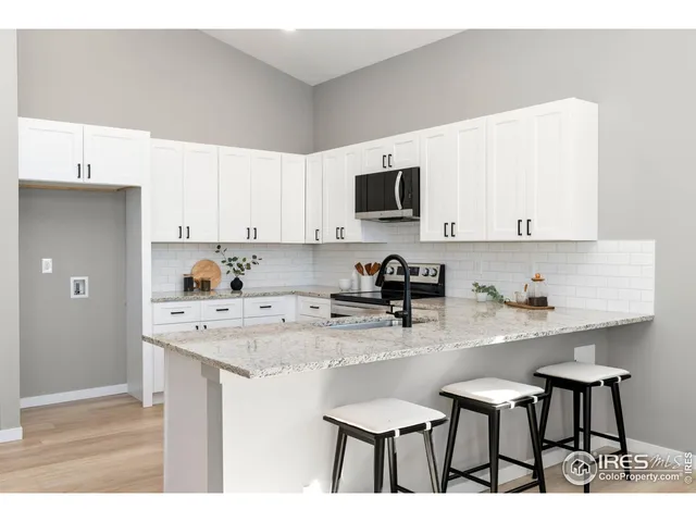 a kitchen with stainless steel appliances kitchen island granite countertop a sink and cabinets