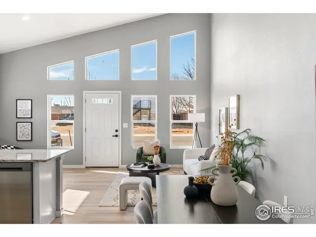 a living room with furniture flowerpot and wooden floor